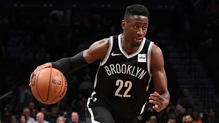 Nets guard Caris LeVert drives the ball against 76ers guard...