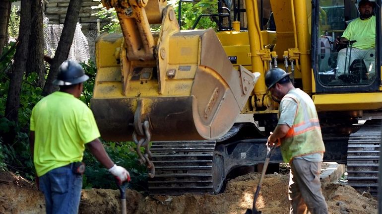 Work underway July 30 on a drainage project and repaving...