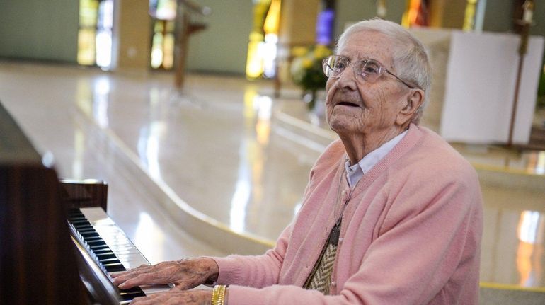 Cecilia Moloughney, 101, plays the piano inside the Maria Regina...