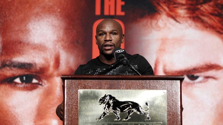 Boxer Floyd Mayweather speaks during a press conference in Las...