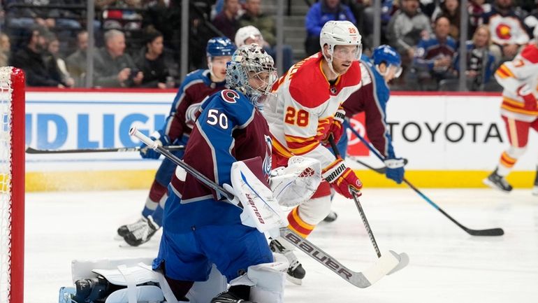 Calgary Flames center Elias Lindholm (28) looks for a pass...