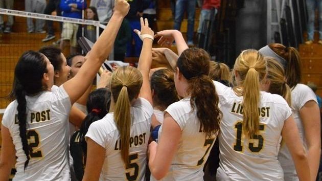 The LIU Post women's volleyball team huddles before a game.