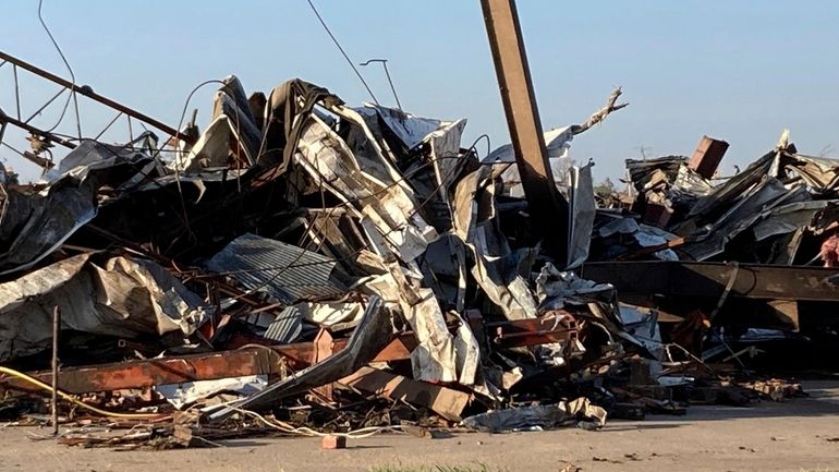 Debris covers a damaged structure in Rolling Fork, Miss,. on...