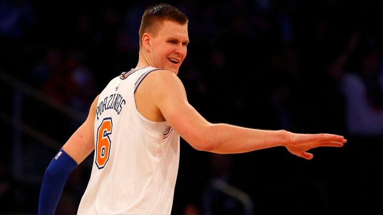 Knicks forward Kristaps Porzingis reacts after hitting a three-point shot...