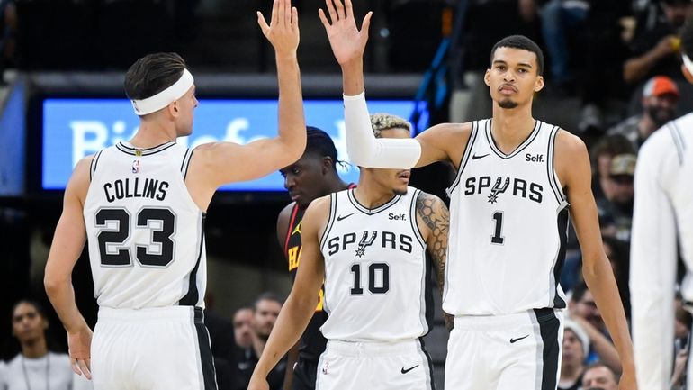 San Antonio Spurs' Victor Wembanyama (1) and Zach Collins (23)...