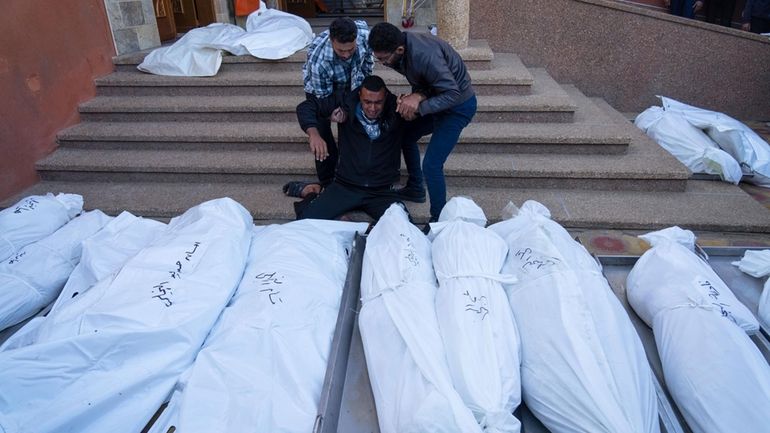 Palestinians mourn their relatives killed in the Israeli bombardment of...