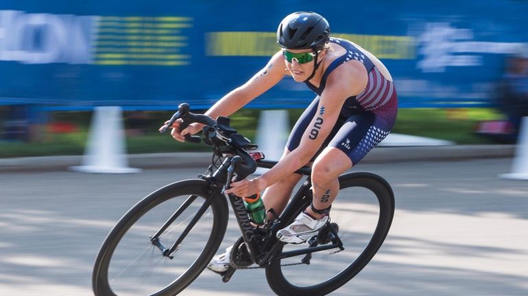 Taylor Knibb, of the United States, rides in the women's...