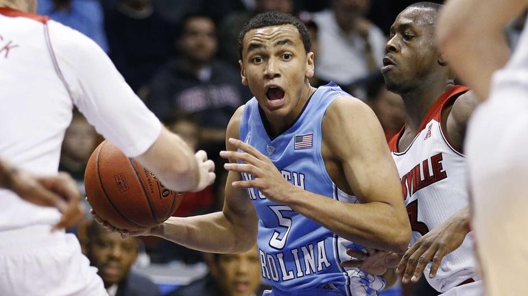 Louisville's Chris Jones (3) pressures North Carolina's Marcus Paige (5)...