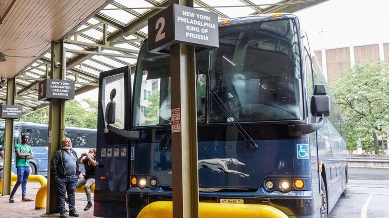 Passengers at a Greyhound bus terminal.  