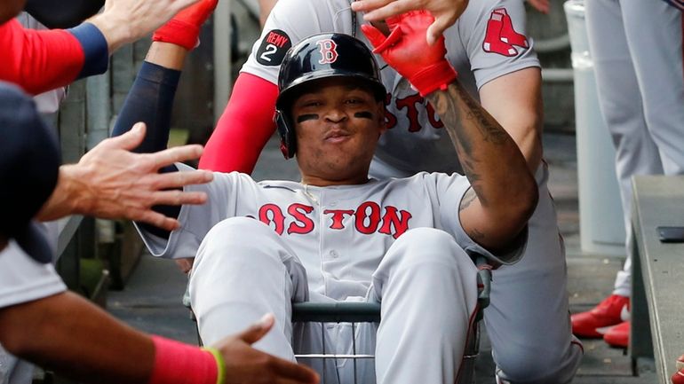 Rafael Devers of the Red Sox celebrates his first-inning home run...