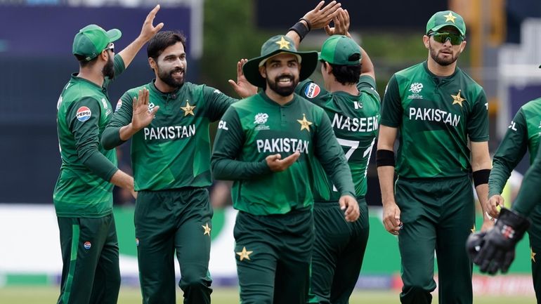 Pakistan's Mohammad Amir, second left, celebrates with teammates after the...