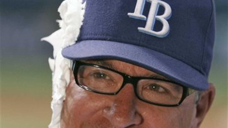 Rays manager Joe Maddon smiles after taking a shaving cream...