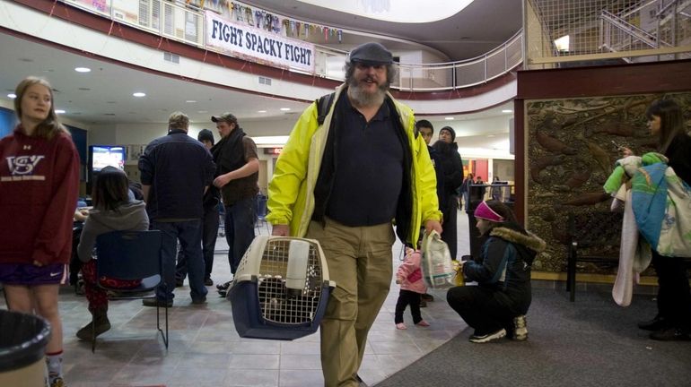 Charles Bingham heads back home with his cats after a...