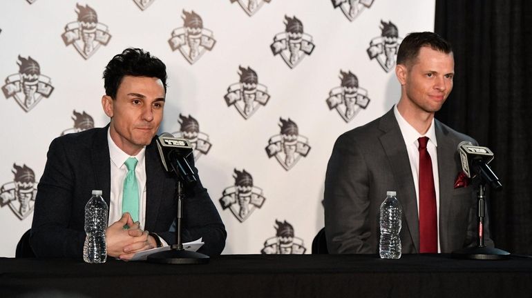 Liberty general manager Jonathan Kolb (left) introduces Walt Hopkins (right)...