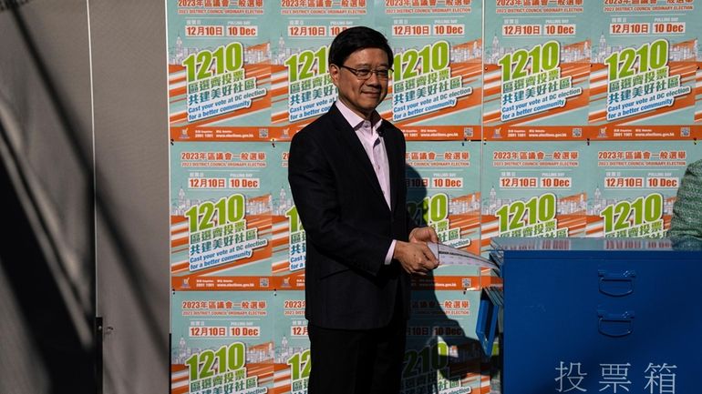 Hong Kong's Chief Executive John Lee casts his ballot at...