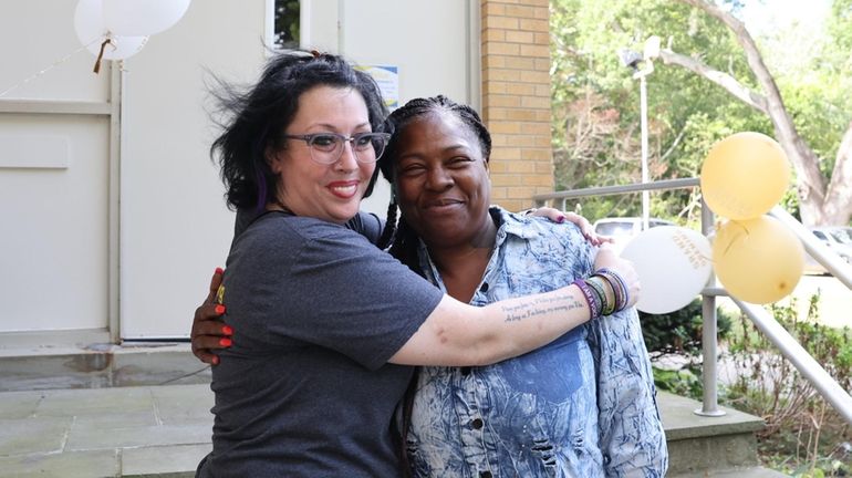 Danielle Smith, 39, of Hauppauge, left, hugs her friend Donna...