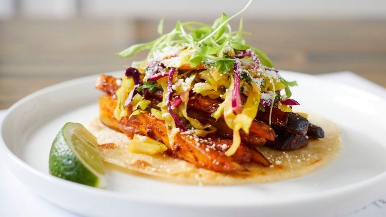 A rainbow carrot taco with al pastor sauce, curtido and cotija...