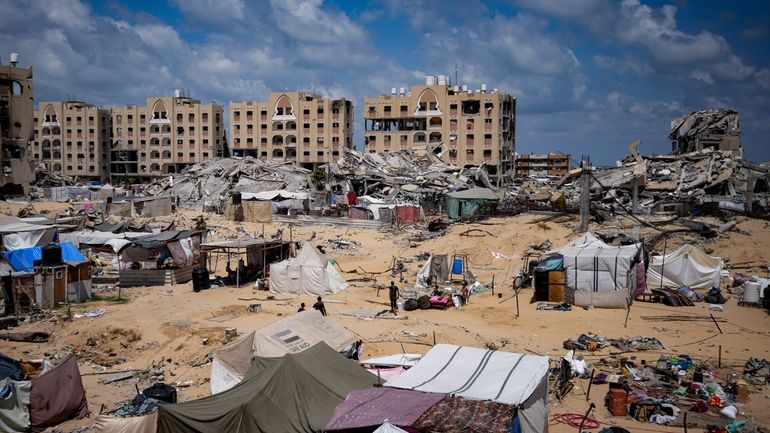 Palestinians displaced by the Israeli air and ground offensive on...