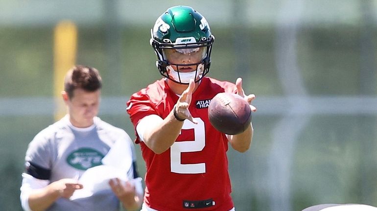 Zach Wilson of the New York Jets runs drills during minicamp...