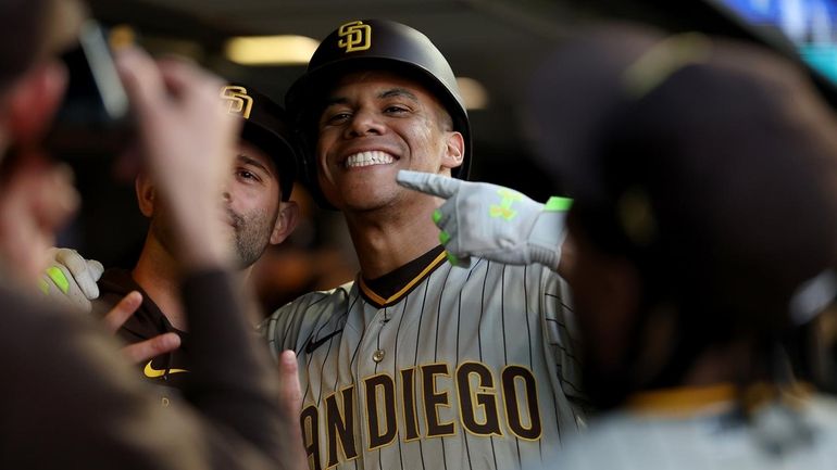 Juan Soto of the Padres is congratulated by teammates after he...