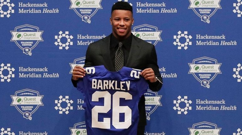 Giants running back Saquon Barkley poses for photos during a...