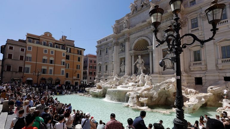 Tourists admire the Trevi Fountain in Rome, June 7, 2017.