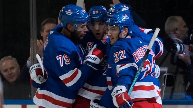 Rangers players celebrate after left wing Will Cuylle scored a goal...