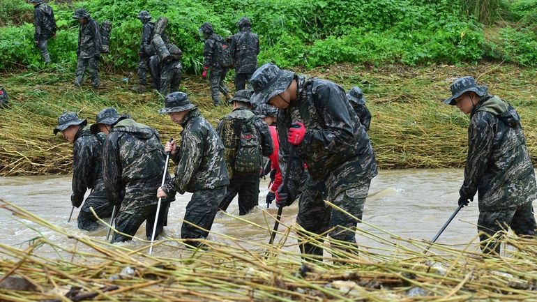 South Korean marines search for missing people in floodwaters in...