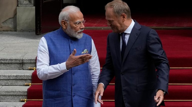 Indian Prime Minister Narendra Modi, left, is greeted by his...