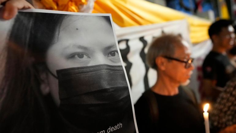 Thai activists hold a portrait of Netiporn Sanesangkhom, a member...