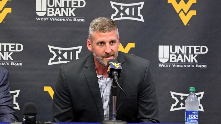 West Virginia interim NCAA college basketball coach Josh Eilert answers...