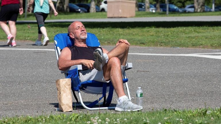 Chris Kozak of East Meadow catches some rays at Eisenhower Park before...