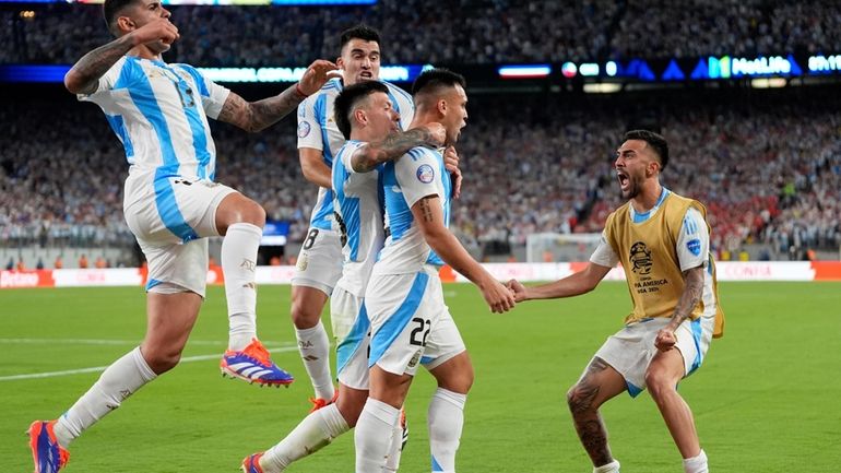 Argentina's Lautaro Martinez, second from right, celebrates scoring his side's...