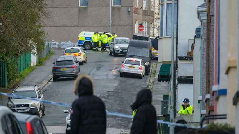 Members of HM Coastguard Search and Rescue gather after homes...