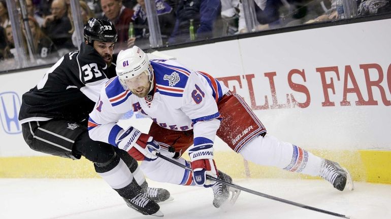 Rangers left wing Rick Nash, right, skates around Los Angeles...