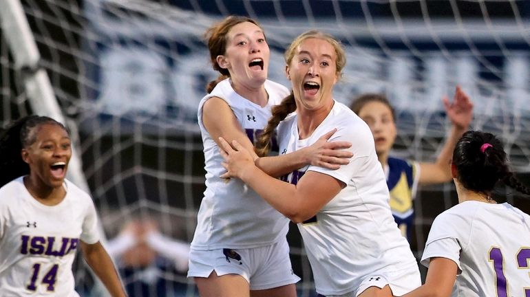 Islip midfielder Carley Mullins (3rd from left) reacts after scoring...