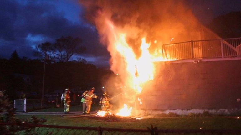 Firefighters battle blaze at a house on Center Street in...