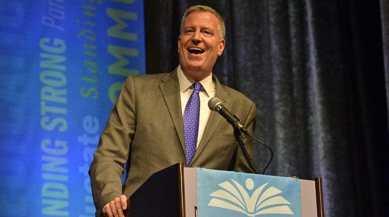 New York City Mayor Bill de Blasio speaks to members...