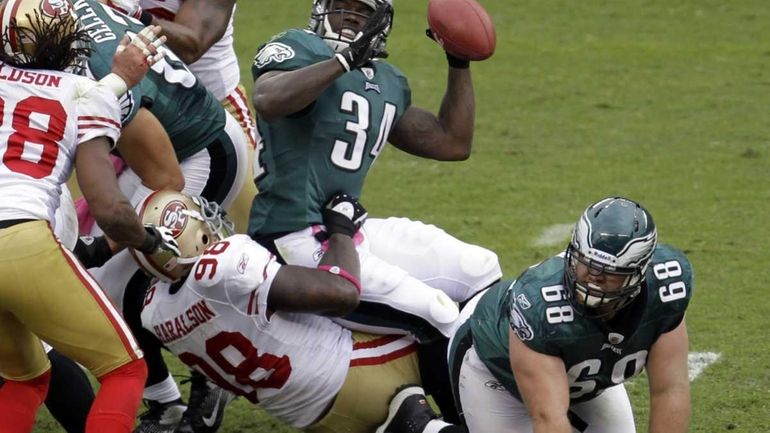 Philadelphia Eagles running back Ronnie Brown fumbles the ball as...