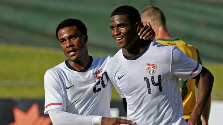 Edson Buddle, right, is congratulated by teammate Robbie Findley after...