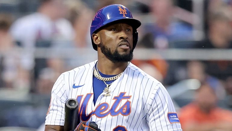 Mets rightfielder Starling Marte reacts after striking out to end...