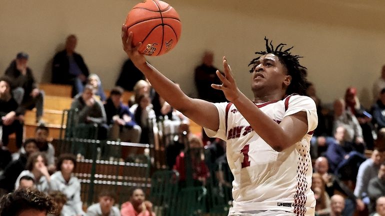 Bay Shore guard Carter Wilson takes the steal in for...