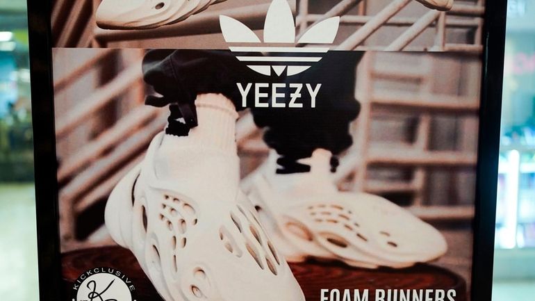 A sign advertises Yeezy shoes made by Adidas at Kickclusive,...