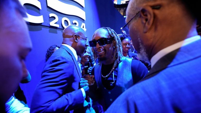 Lil Jon shakes hand with Sen. Raphael G. Warnock, D-Ga.,...