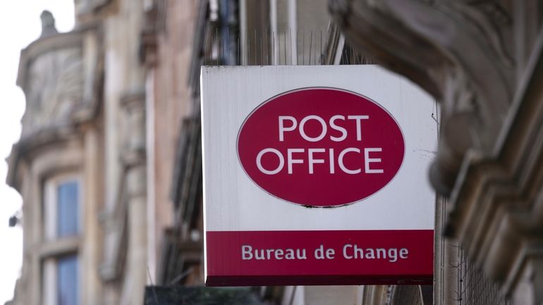 A logo of a post office is displayed in London,...