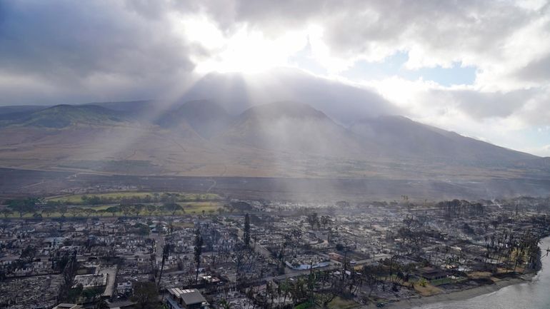 Rays of sunlight pierce through the clouds, Thursday, Aug. 10,...