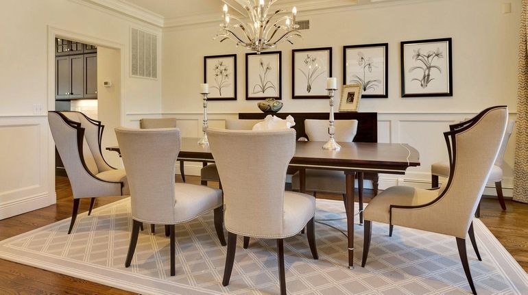 Statement chairs highlight this Woodbury dining room designed by Robyn...