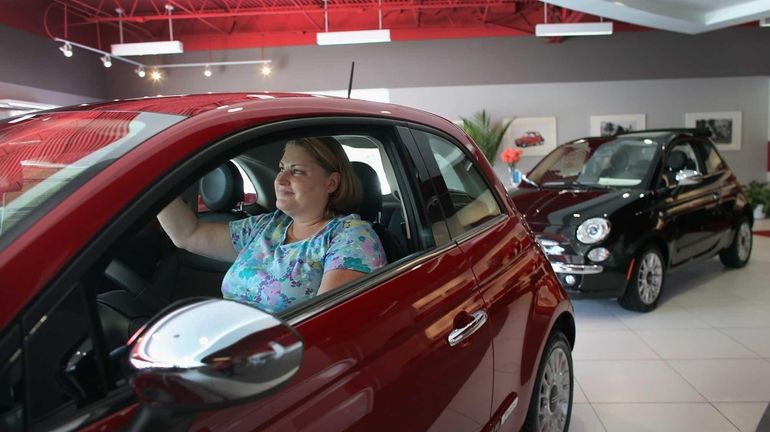 A shopper checks out a Fiat in a North Miami...