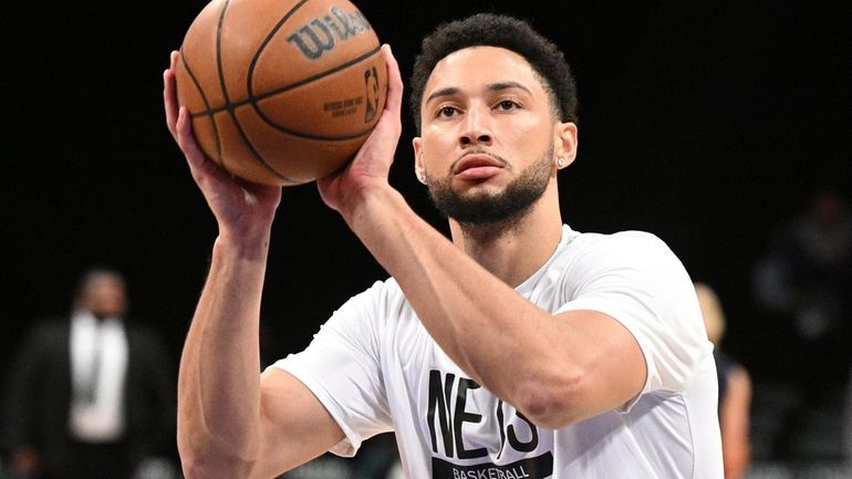 Nets guard Ben Simmons warms up before an NBA basketball...