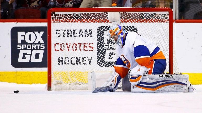 New York Islanders goalie Thomas Greiss pauses on the ice...